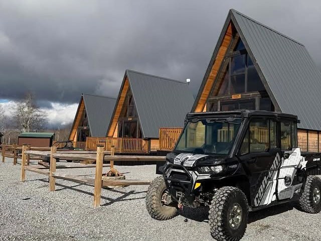Three Stella 70 A-frame cabins with a UTV at WV ATV Resort.