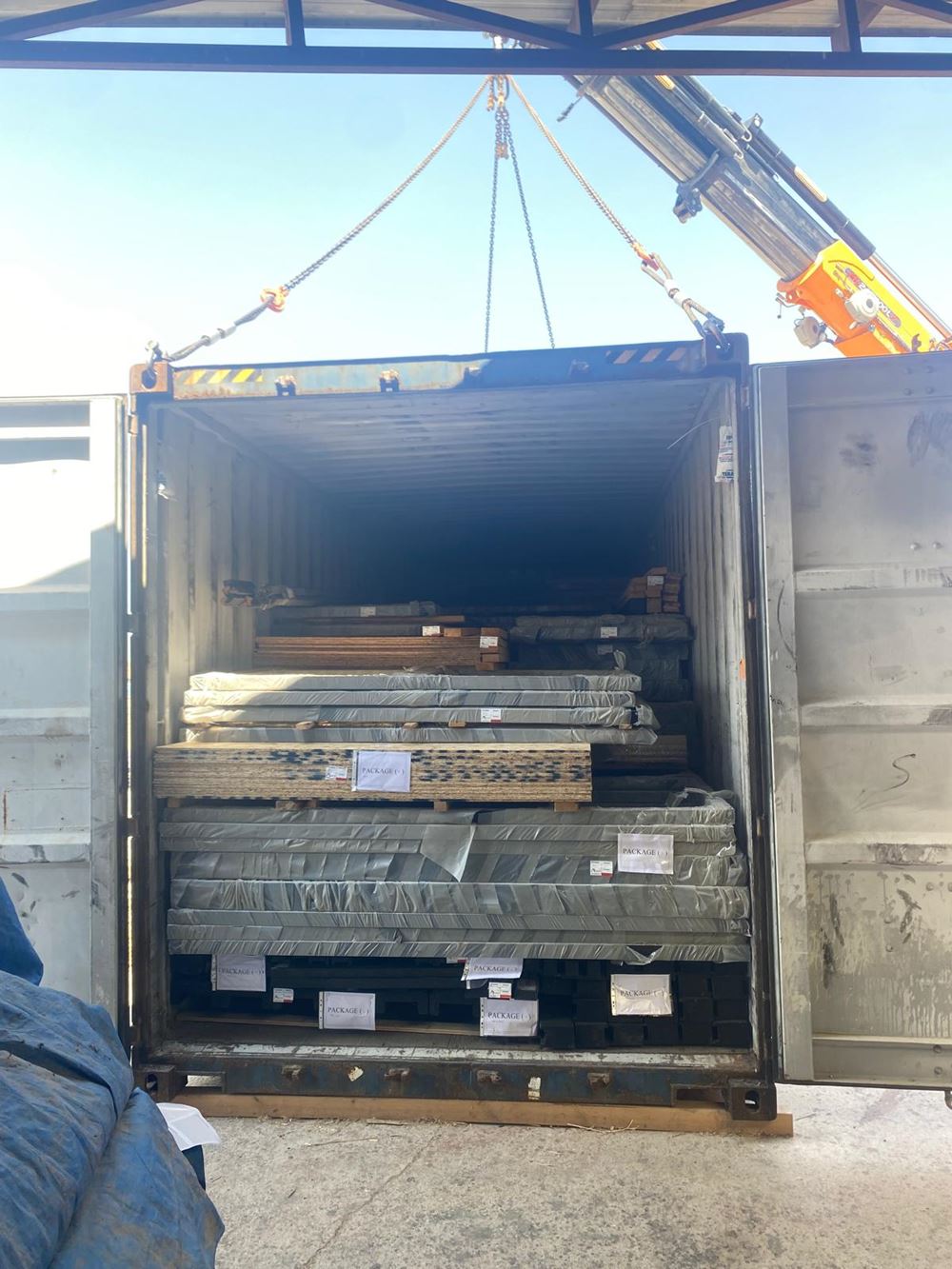 Mixed Stella 53 and Aries 116 cabin kit components packed inside a shipping container for Idaho.