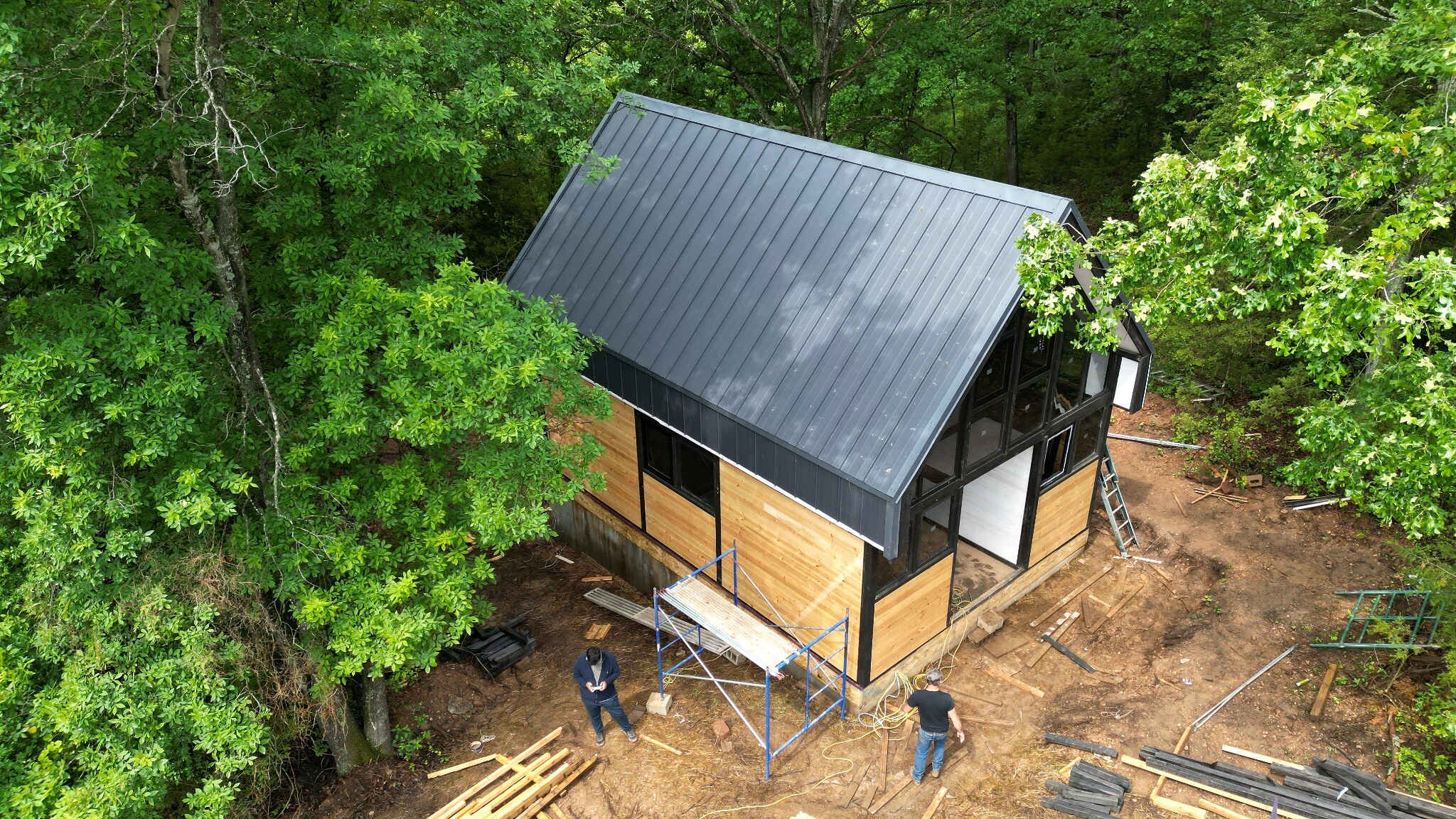 Standing-seam roof installation on the Aries 96 cabin project in Omaha, Arkansas.