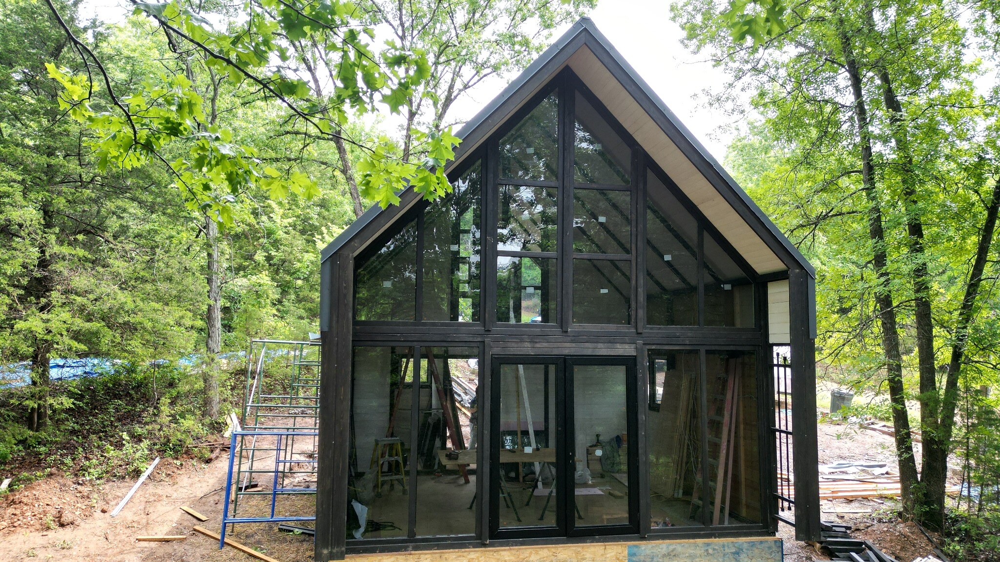Panoramic glass front during construction of the Aries 96 cabin kit in Omaha, Arkansas.
