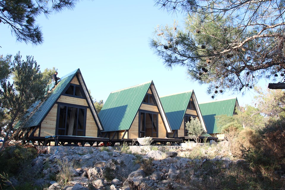 Completed Stella 34 cabins with green roofs among pine trees at Patara.