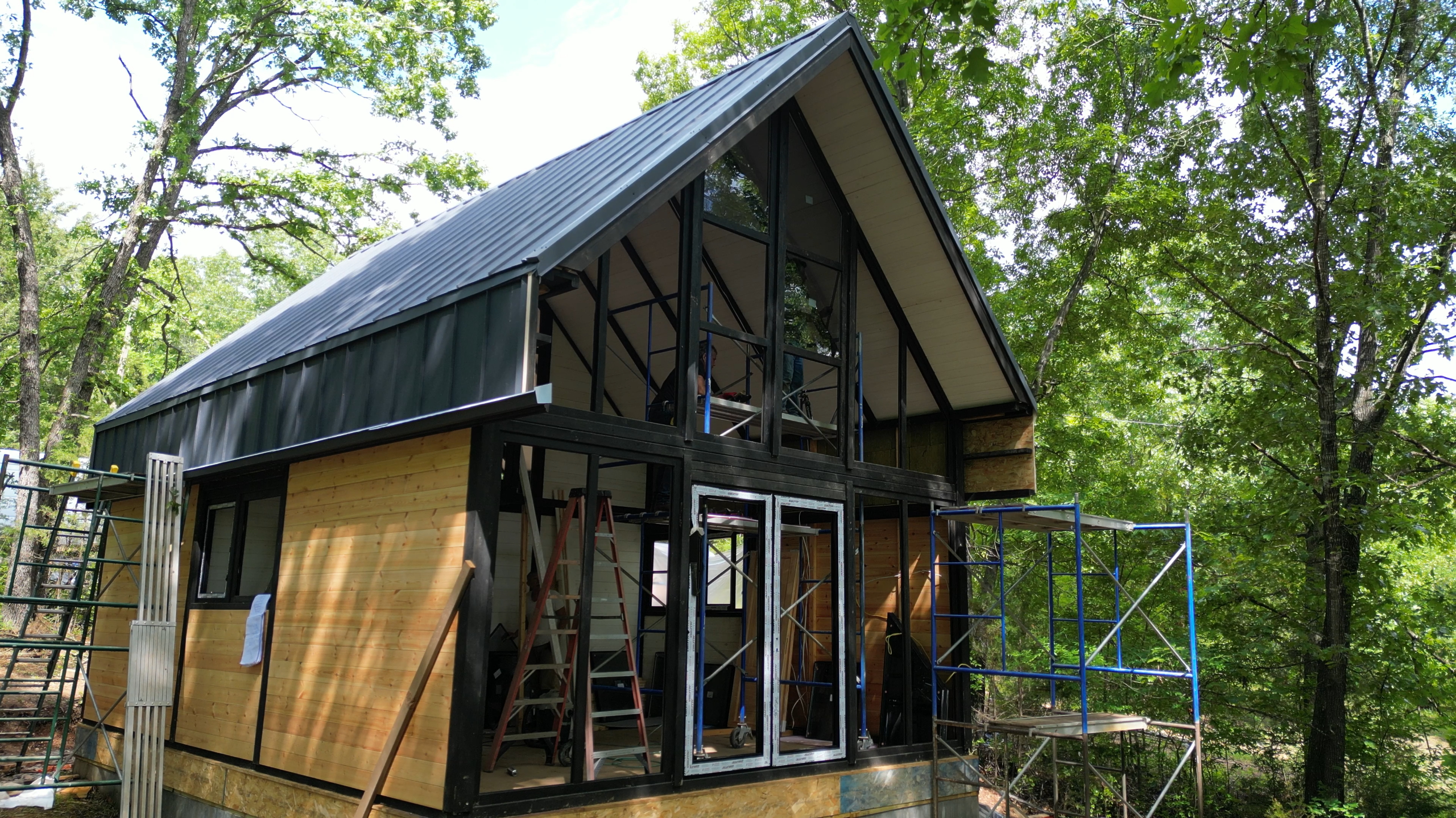Roof structure and panoramic front framing in progress on the Arkansas Aries 96 cabin.