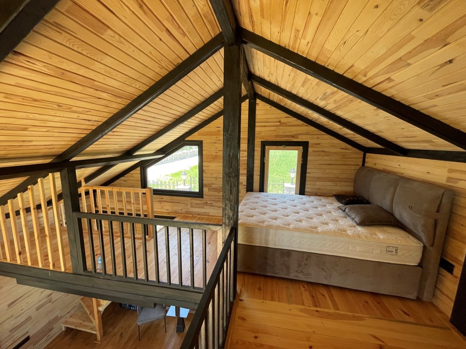 The Libra 72 sleeping loft with timber finishes and an open balustrade.