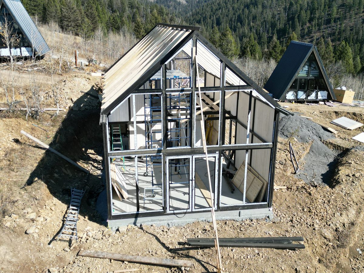 Aries 116 structural frame and glass-front opening during construction in Island Park, Idaho.