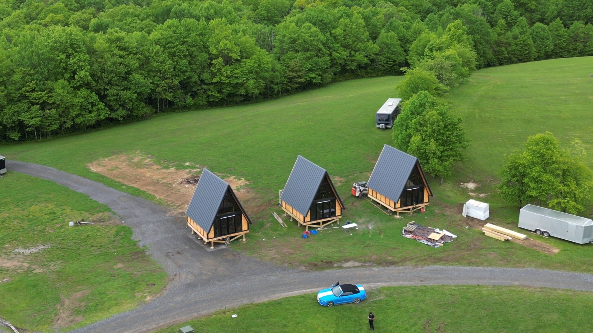 Three Stella 70 A-frame cabins at the structural core-and-shell stage at WV ATV Resort