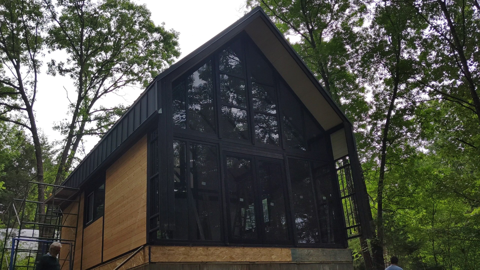 Front glazing during construction at the Aries 96 cabin project in Omaha, Arkansas.