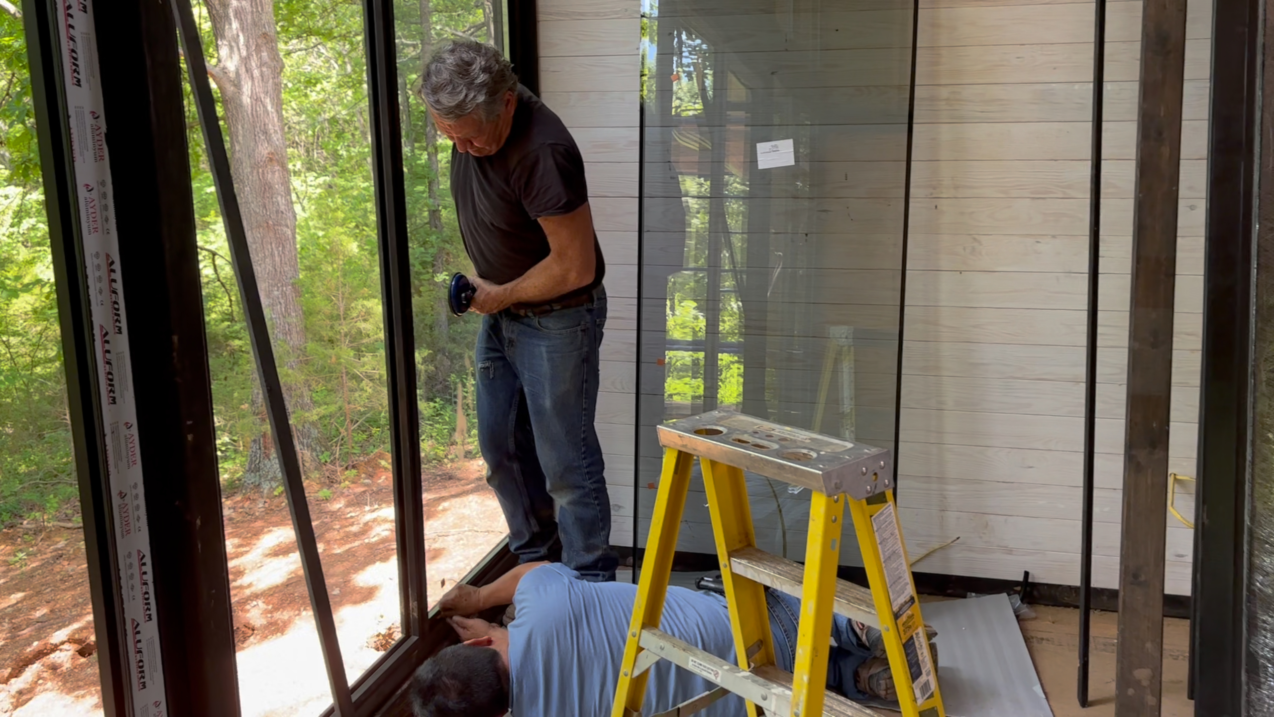 Large panoramic glass panel being positioned during the Arkansas Aries 96 installation.