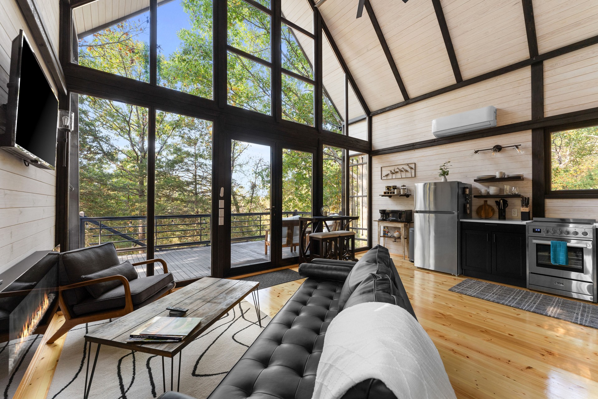 Living room, kitchen and full-height glazing in the completed Aries 96 cabin in Arkansas.