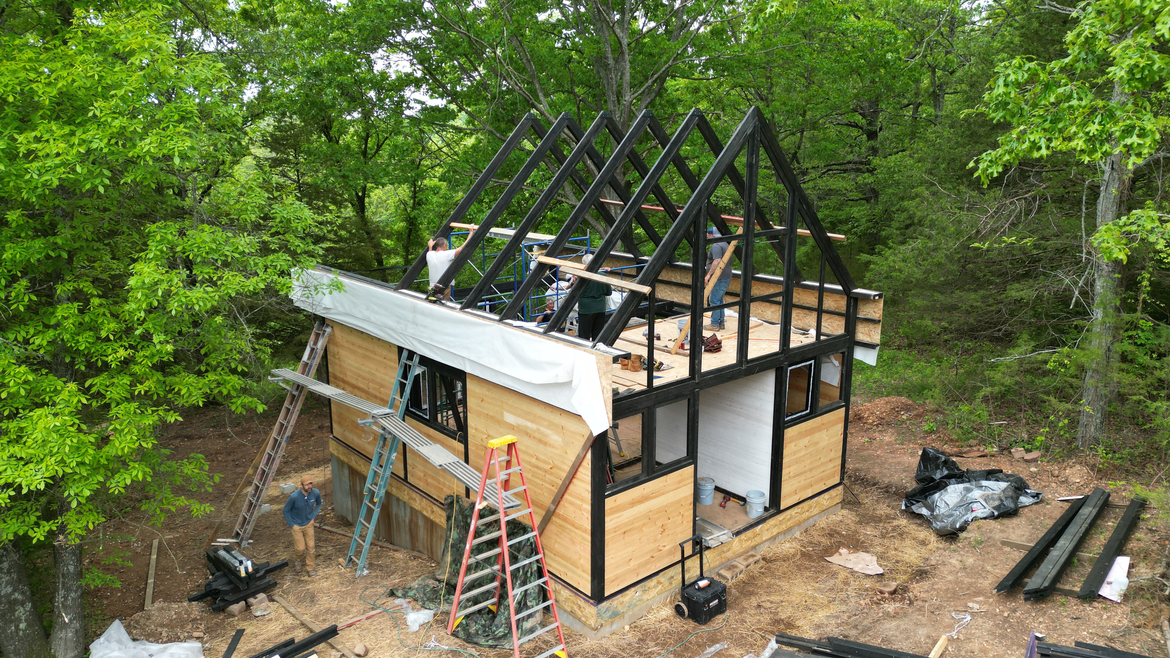 Aerial view of the Aries 96 A-frame roof structure during assembly in Arkansas.