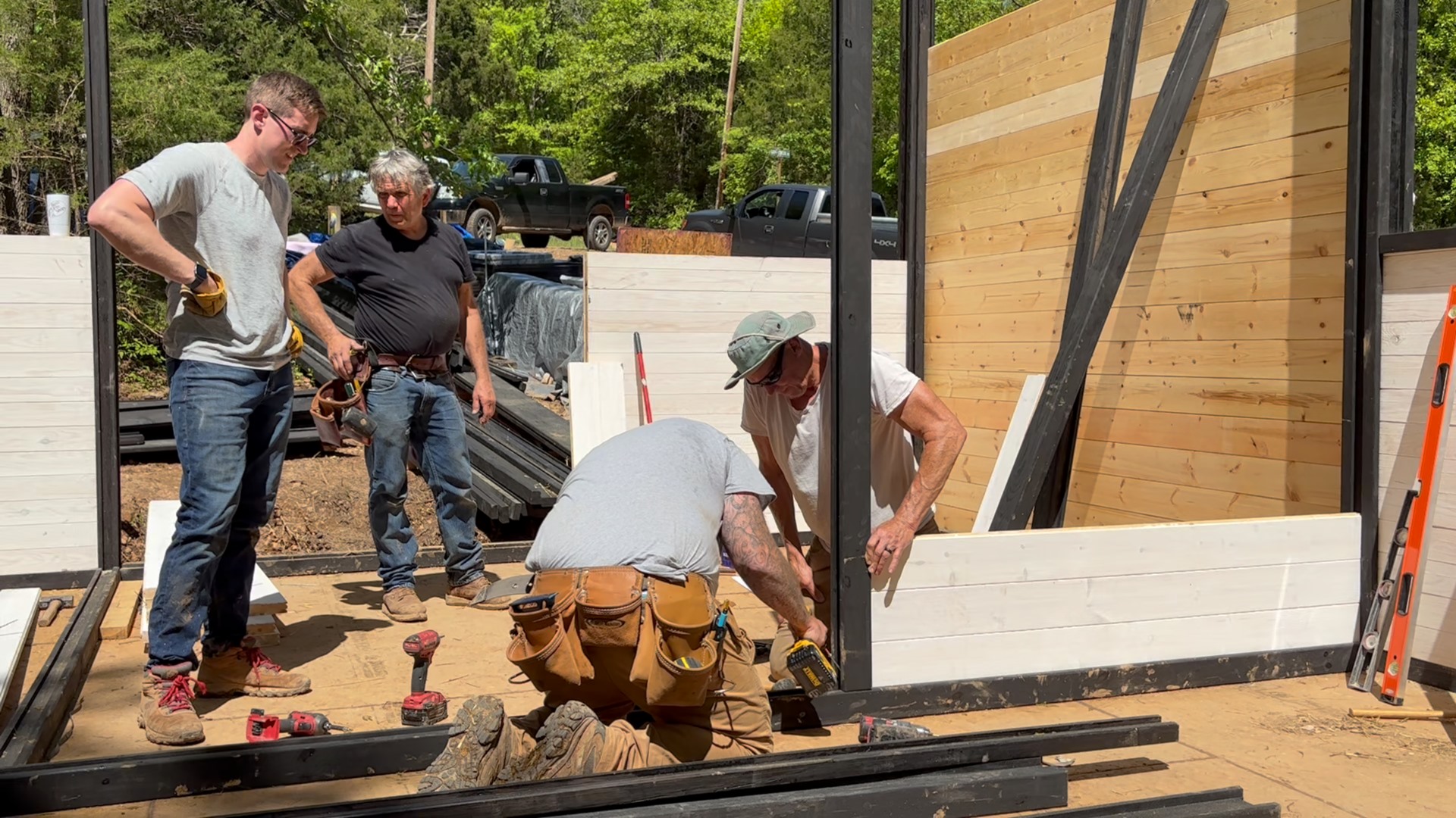 Crew installing factory-cut wall panels for the Aries 96 cabin in Omaha, Arkansas.