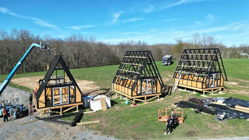 The three primary A-frame structures standing together before roof enclosure. West Virginia / Earlier configuration.