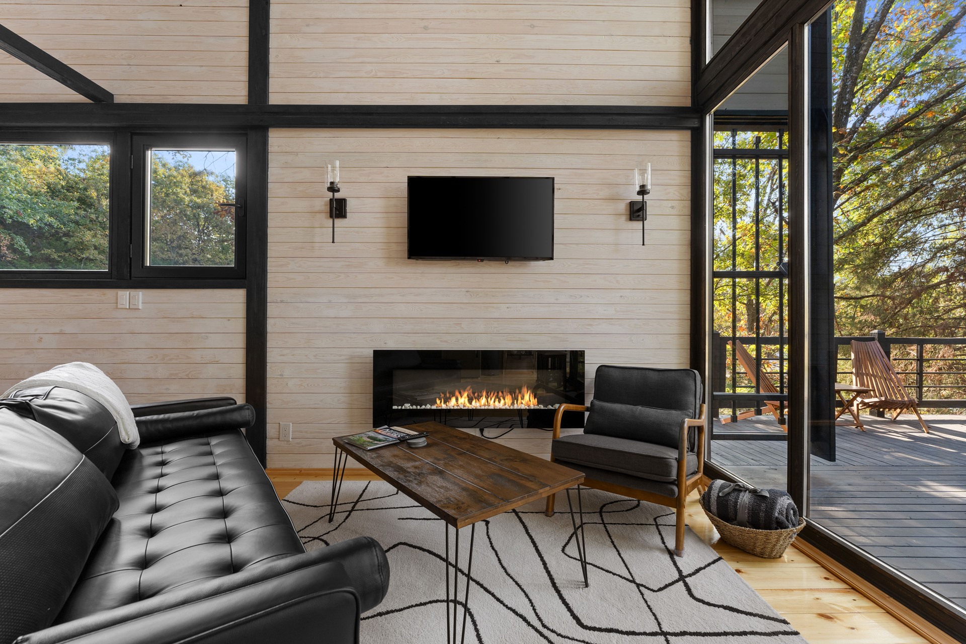 Living room fireplace and deck access at the Aries 96 cabin project in Omaha, Arkansas.