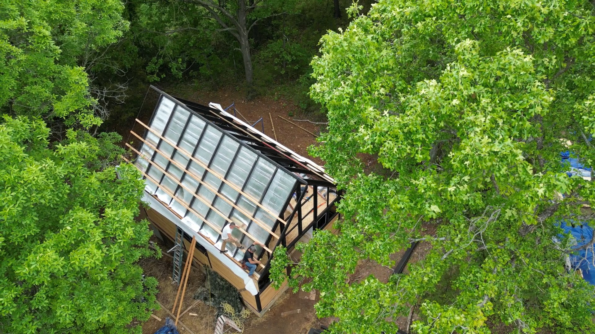 Aerial view of the Aries 96 roof framing stage on the wooded Arkansas site.
