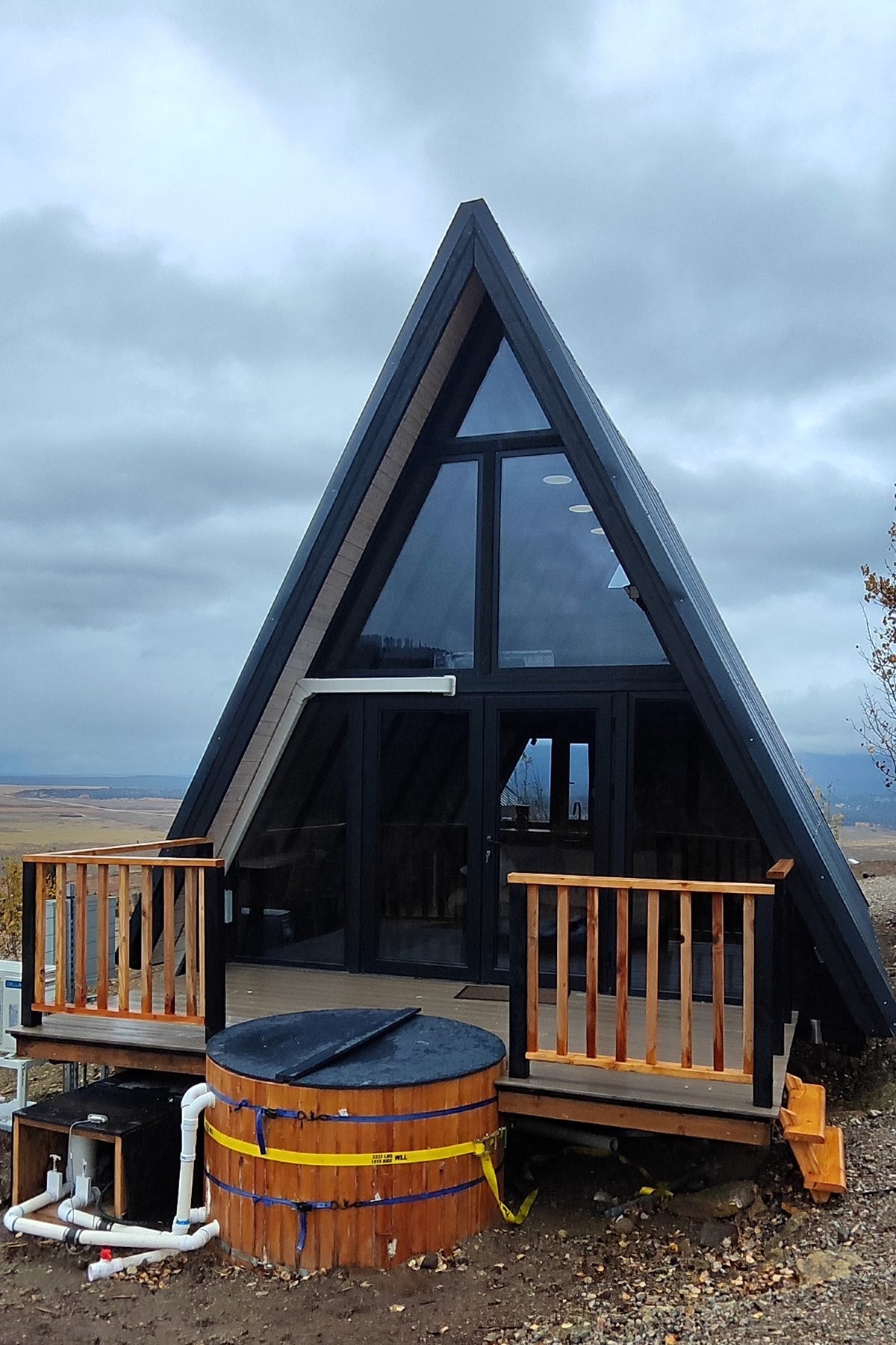 Completed Stella 53 A-frame cabin viewed from the glass-front entrance in Island Park, Idaho.