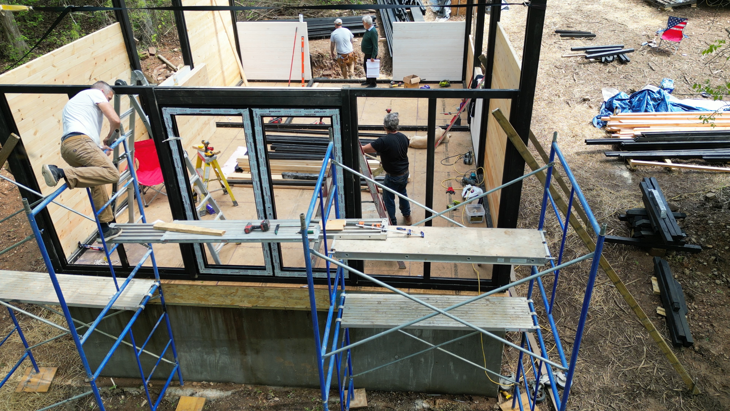 Panoramic front structural frame being installed with scaffolding on the Arkansas Aries 96 cabin.