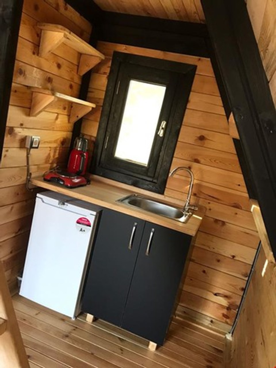 The compact kitchen inside a completed Patara cabin.