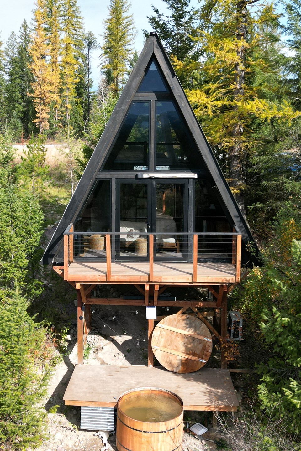 Completed Stella 53 with raised outdoor platforms and a hot tub in Montana. Site amenities are project-specific.