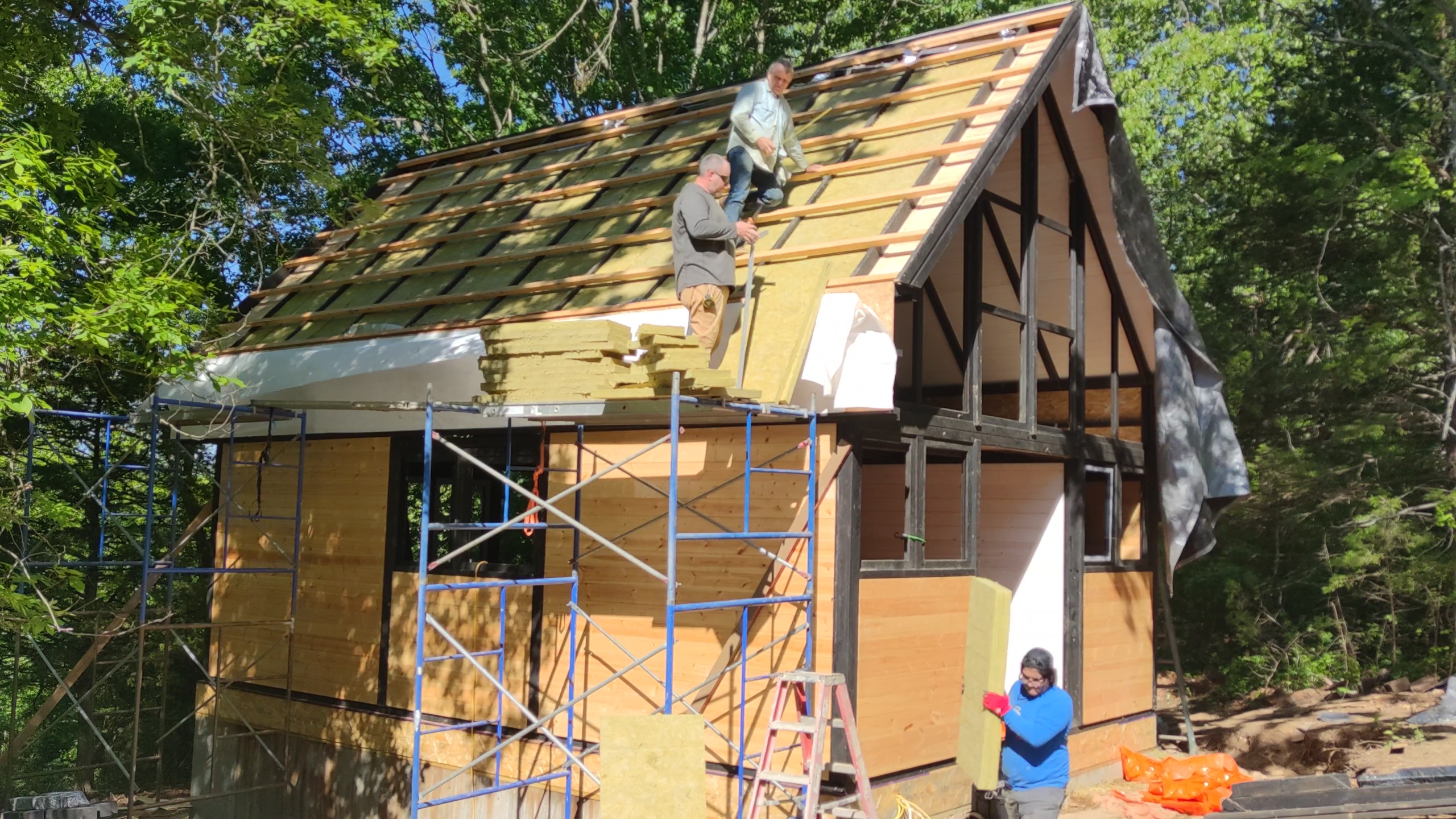 Roof insulation being installed between the Aries 96 rafters in Arkansas.