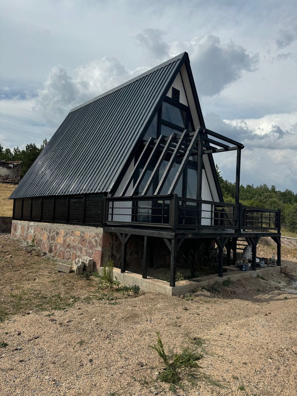 Dark-clad Stella 70 cabin exterior in the Private cabin project in Turkey landscape. Earlier Stella 70 application; project finishes and amenities vary.