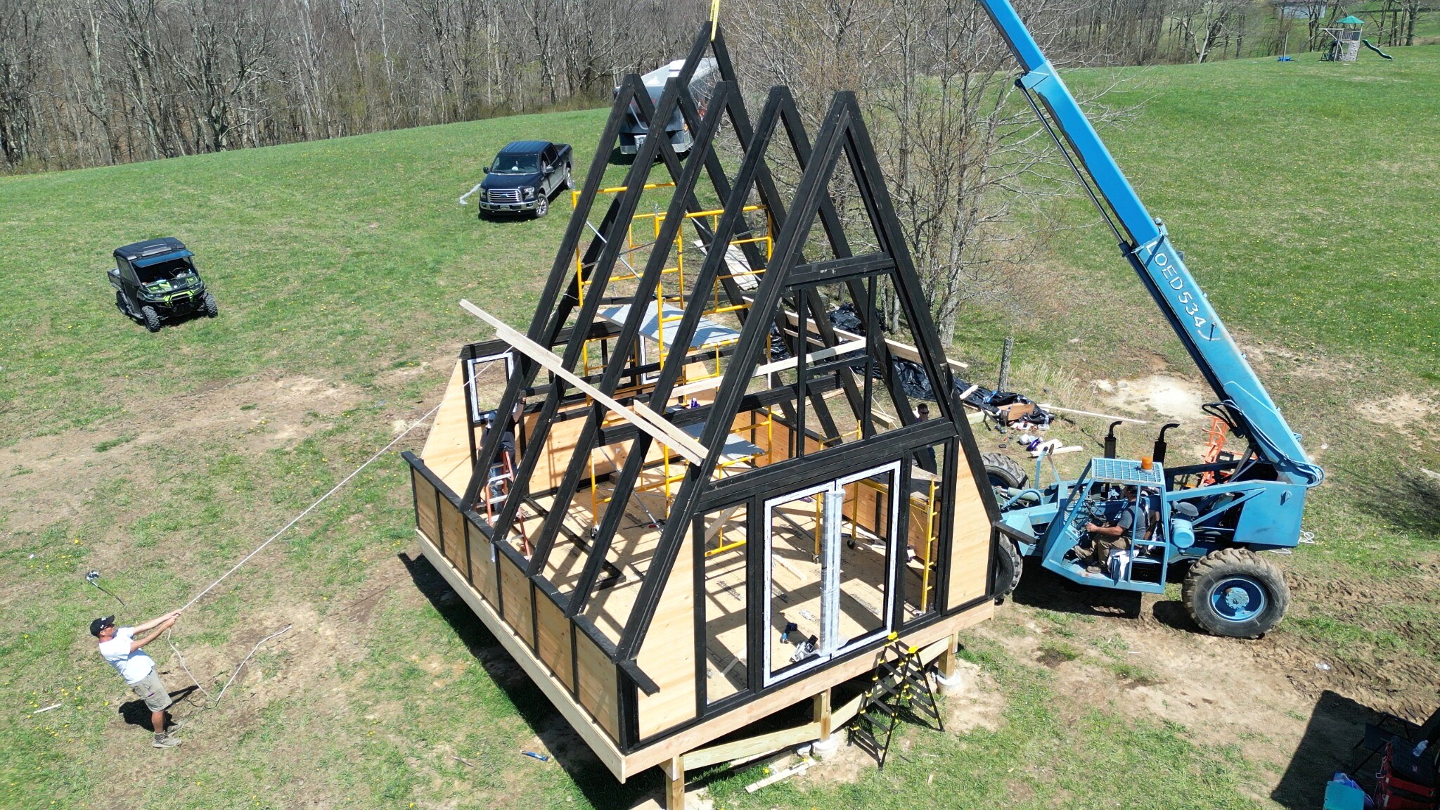 Crew positioning prefabricated Stella 70 structural frames during assembly at WV ATV Resort