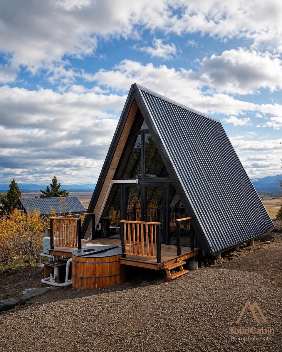 A completed Stella 53 cabin with a deck and mountain setting.