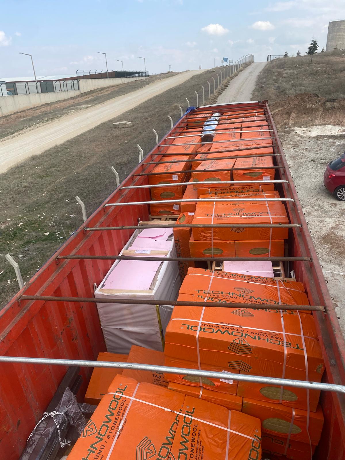 Insulation packages loaded inside the shipping container for the Arkansas Aries 96 cabin kit.