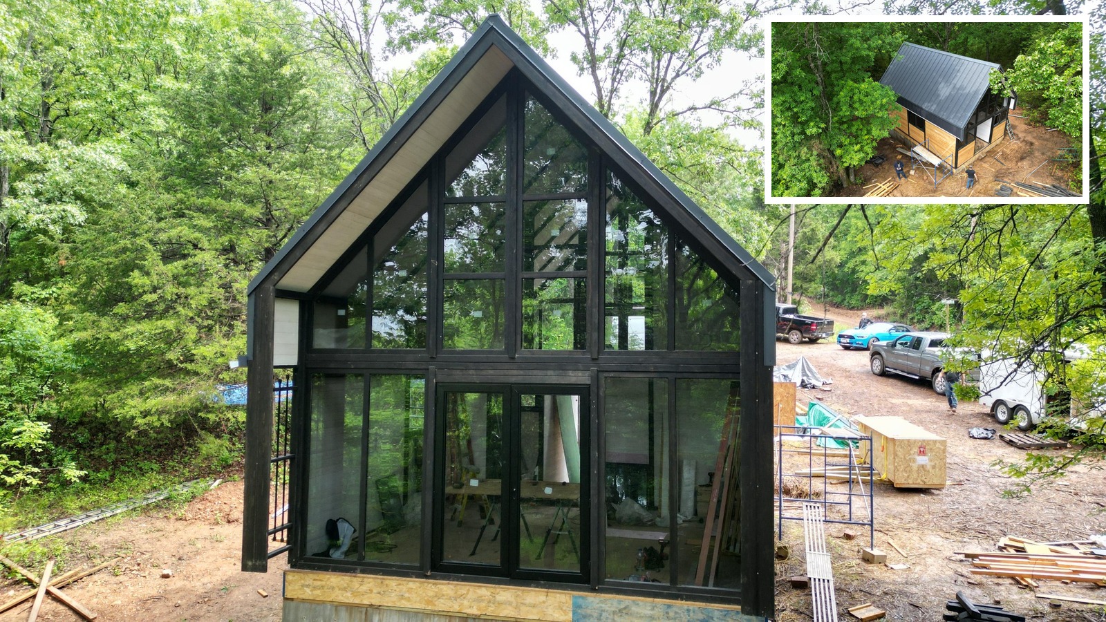 Aries 96 modern A-frame cabin in Arkansas with the metal roof, front glass facade, and exterior shell largely completed.