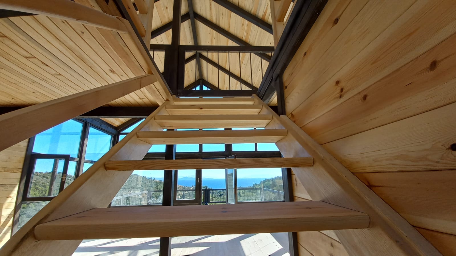 Factory-supplied timber components and stairs in a completed SolidCabin project