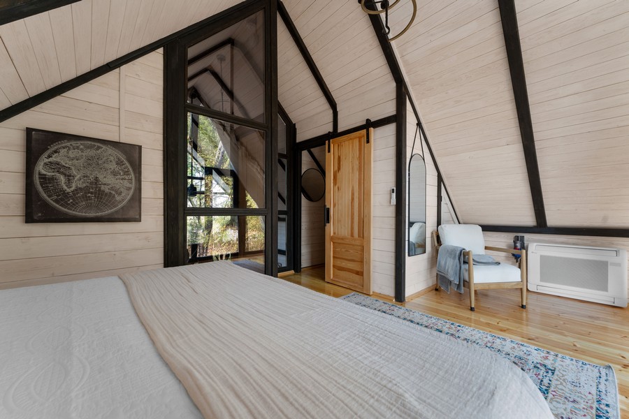 Bedroom interior in the completed Aries 96 cabin in Omaha, Arkansas.