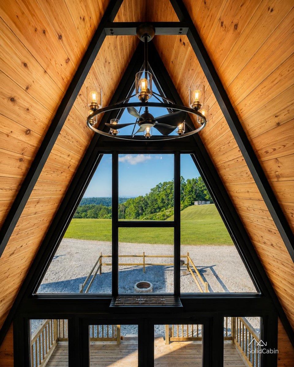 Triangular front glazing and chandelier at WV ATV Resort. Lighting and furnishings are project-specific.