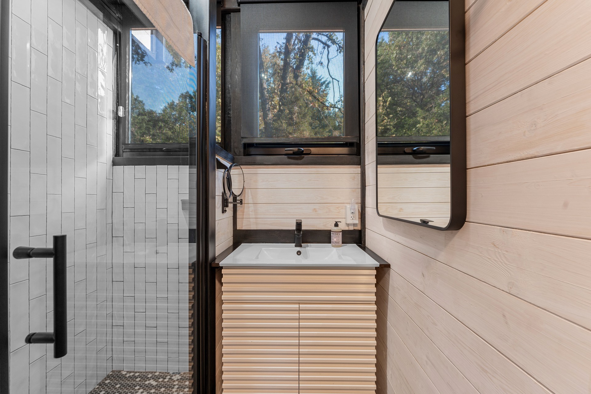 Bathroom shower and vanity in the completed Aries 96 cabin in Omaha, Arkansas.