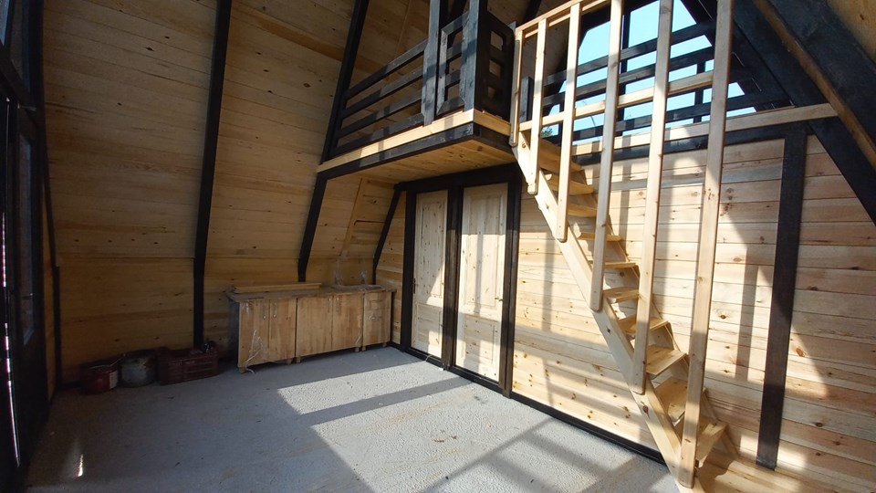 Stella 70+ living area with loft stair and timber walls. Kocaeli / Earlier Stella 70+ revision.