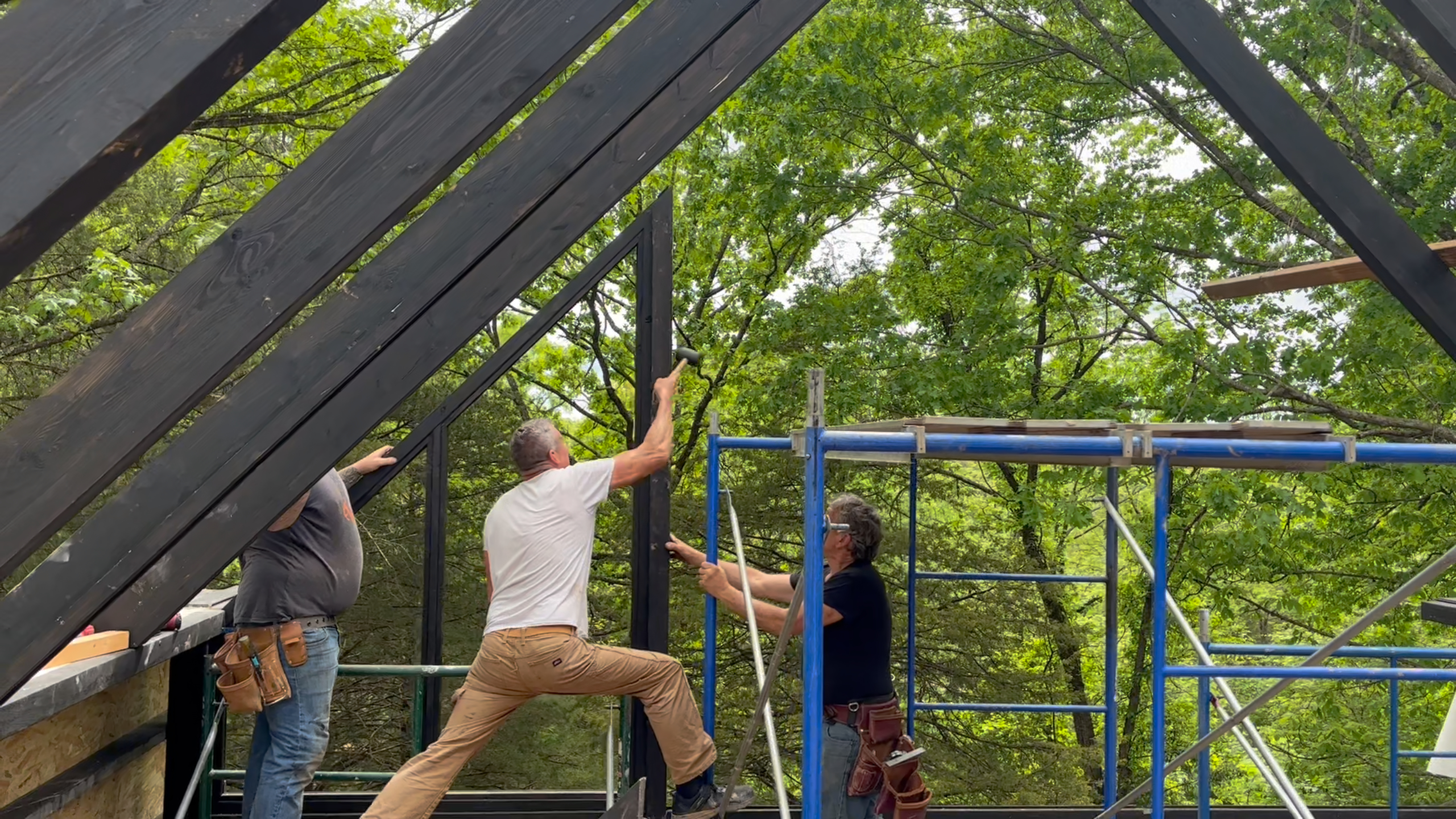 A-frame gable structure being assembled at the Arkansas Aries 96 cabin.