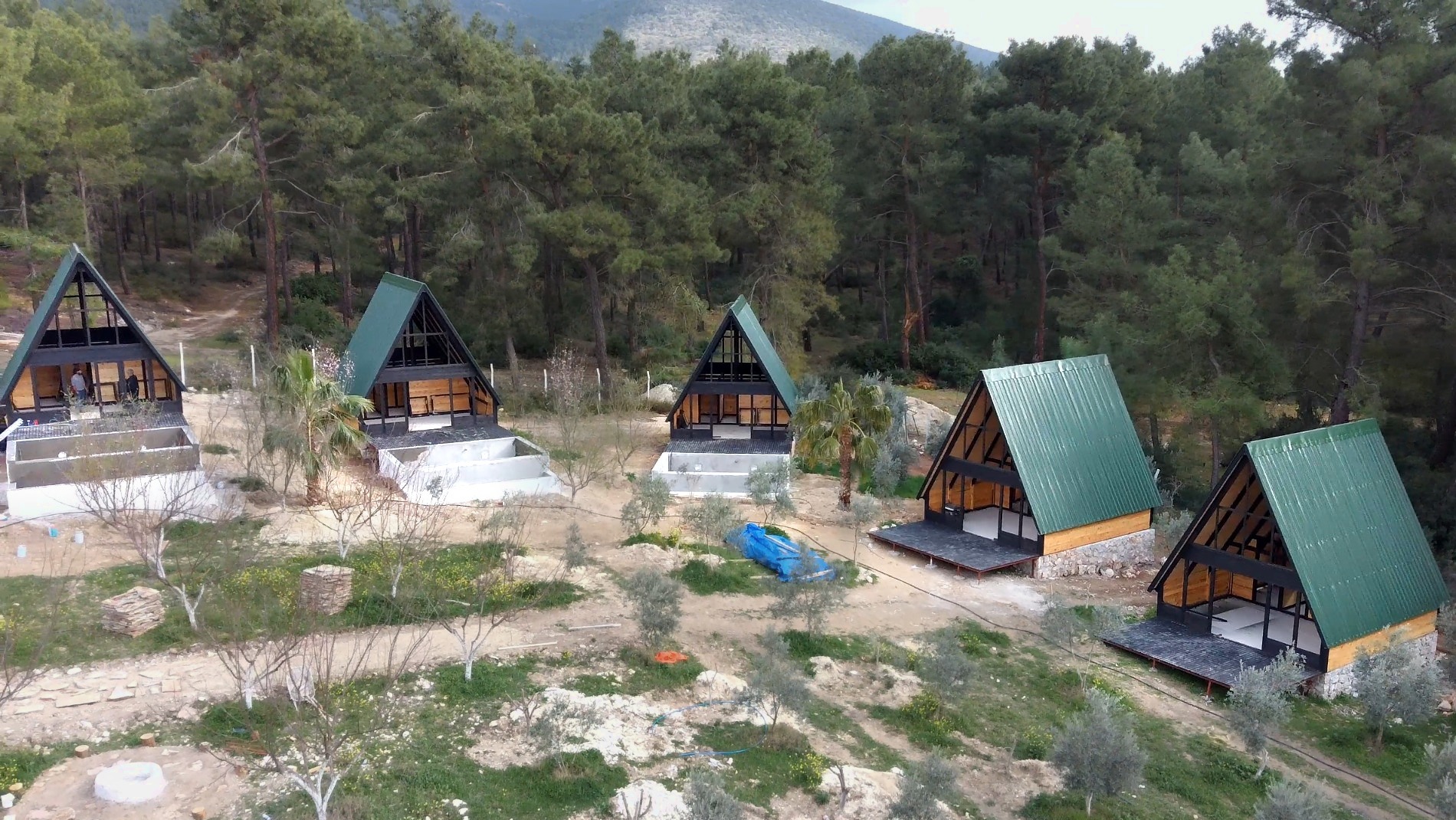Stella 70 A-frame cabin hotel under construction in a forested mountain setting in Turkey.