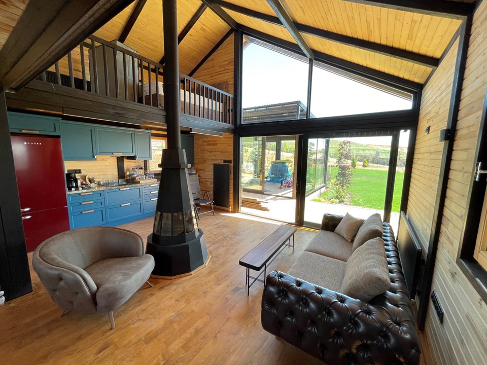 Furnished Libra 72 living space beneath the loft, facing the glazed front.