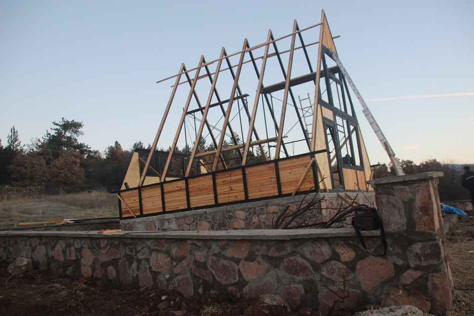 Stella 70 A-frame structural skeleton on the stone base. Earlier Stella 70 application; project finishes and amenities vary.