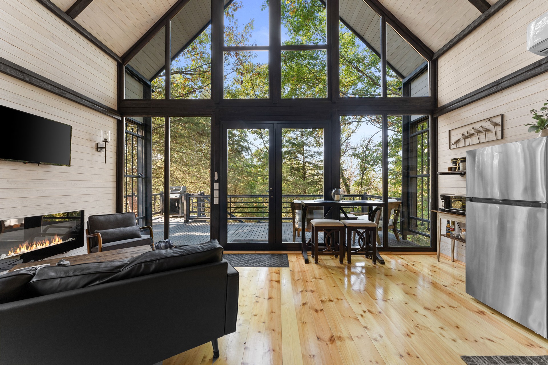 Open-plan living room and glazed facade inside the completed Arkansas Aries 96 cabin.