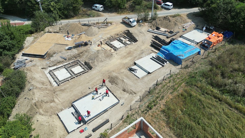 Cabin foundations and stored structural components at the resort site