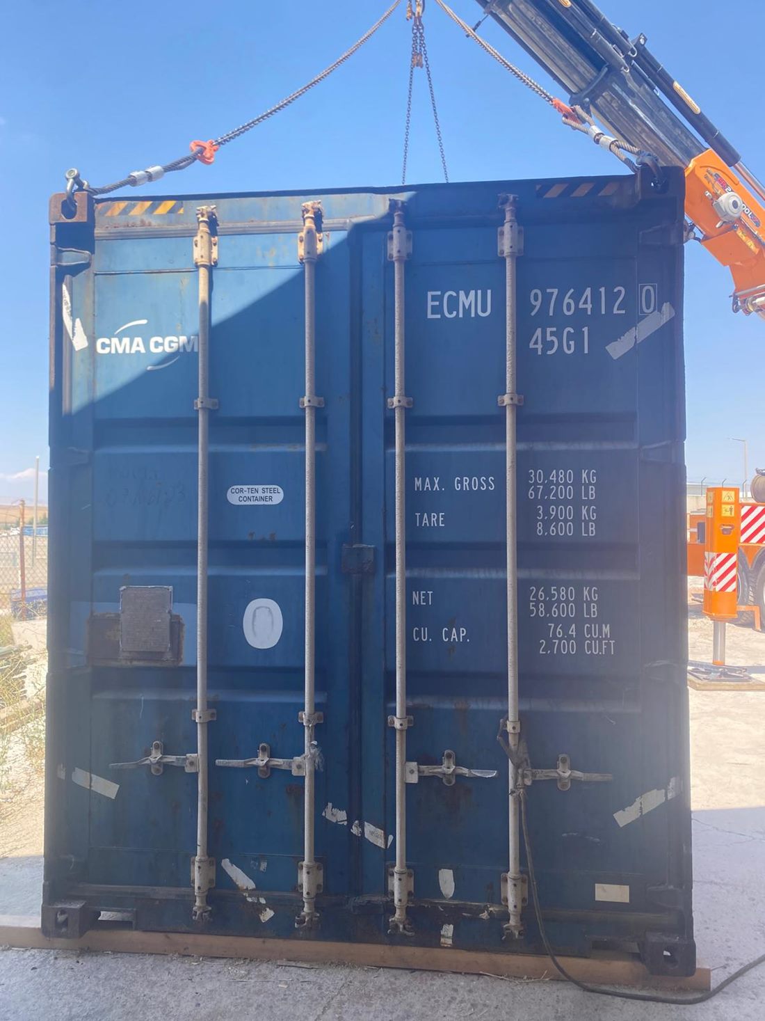 A shipper-owned container being handled by crane for the Island Park, Idaho cabin-kit shipment.